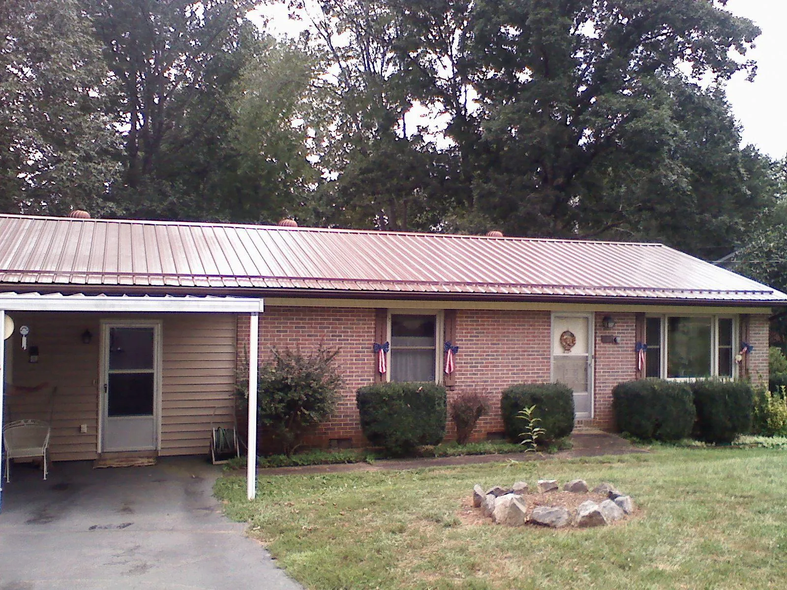 Bronze metal roof and carport on a brick ranch home — Roof Repair work by our crew in Westfield